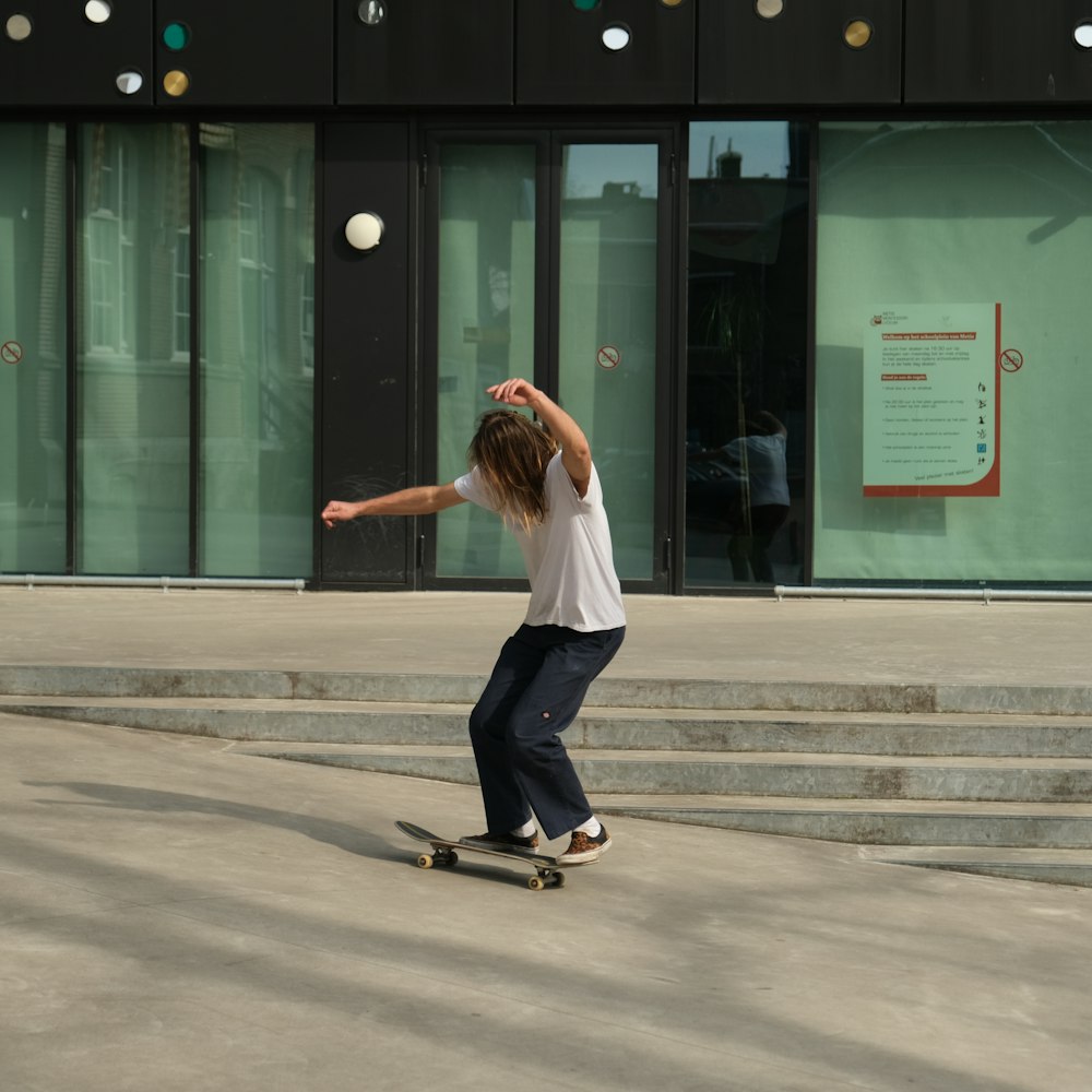 a young man riding a skateboard down a street