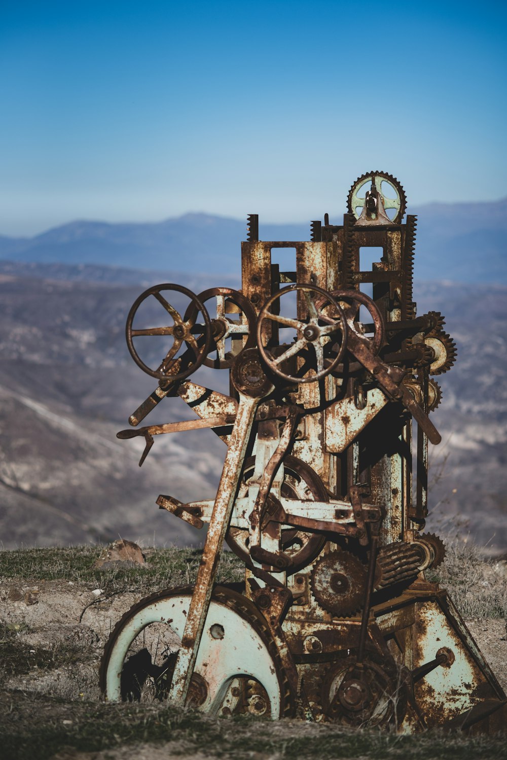 a rusted out machine sitting on top of a hill
