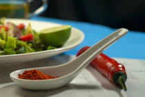 a plate of food with a salad and a spoon