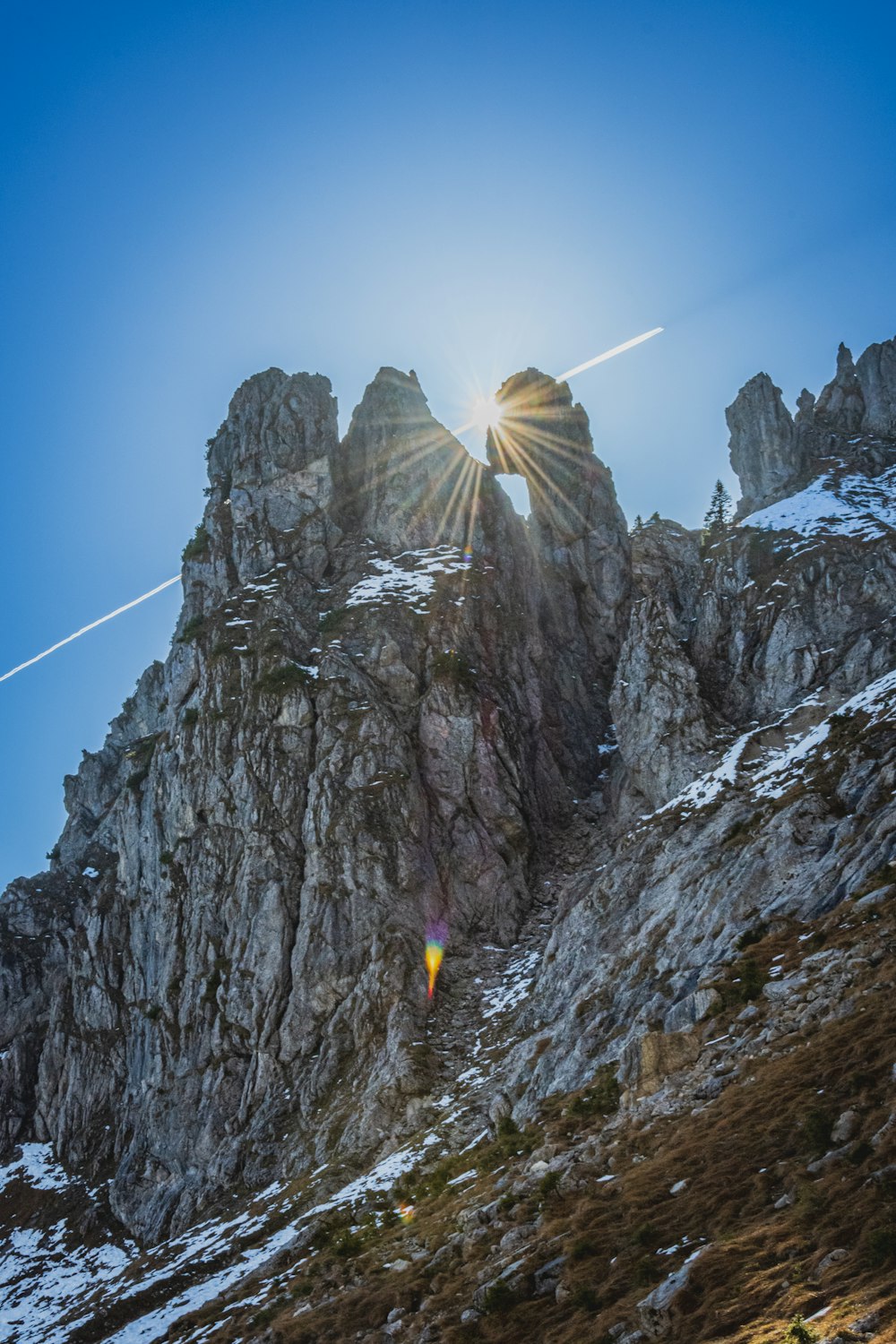 the sun shines brightly on a rocky mountain