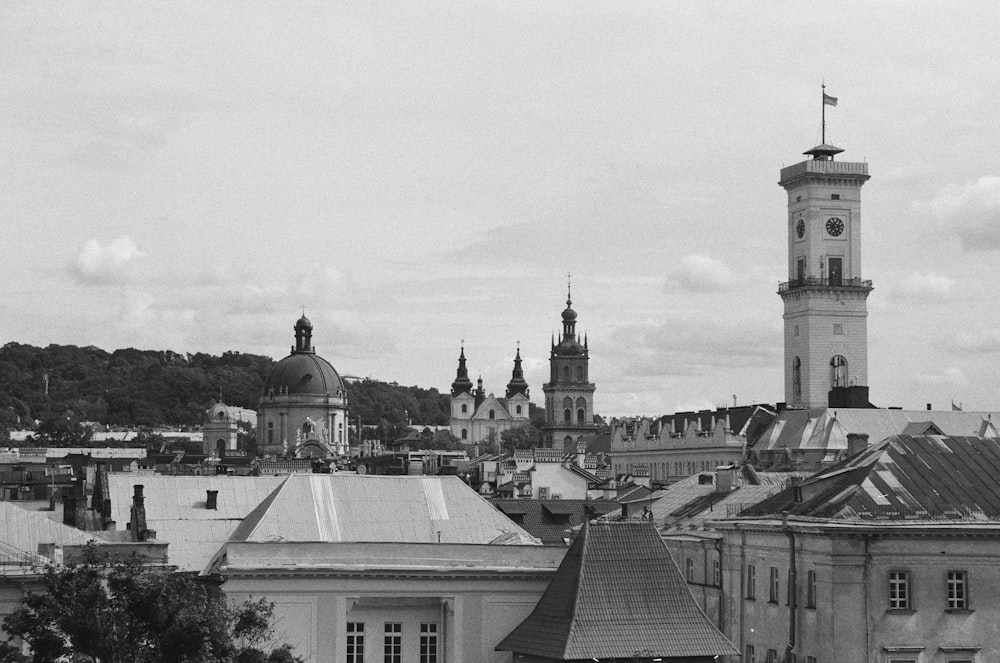 a black and white photo of a city with a clock tower