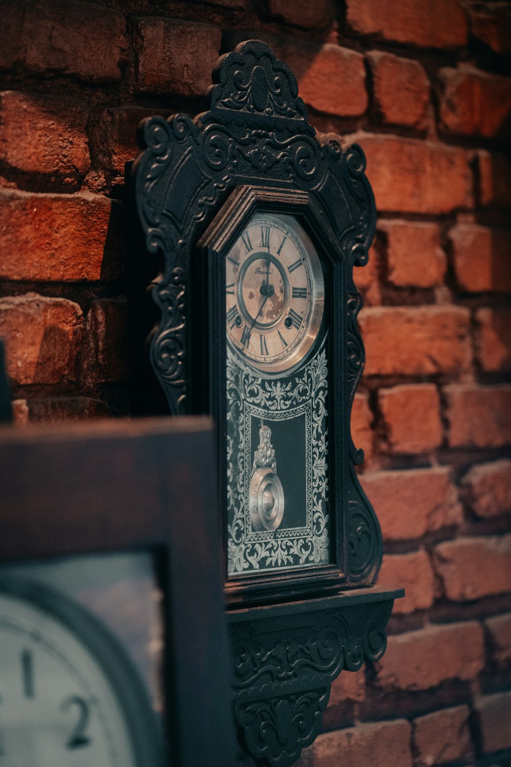 a clock that is on the side of a brick wall