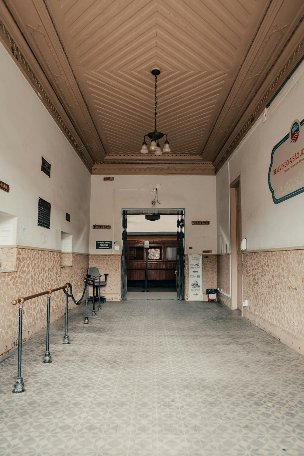 a large room with a metal railing and a sign on the wall