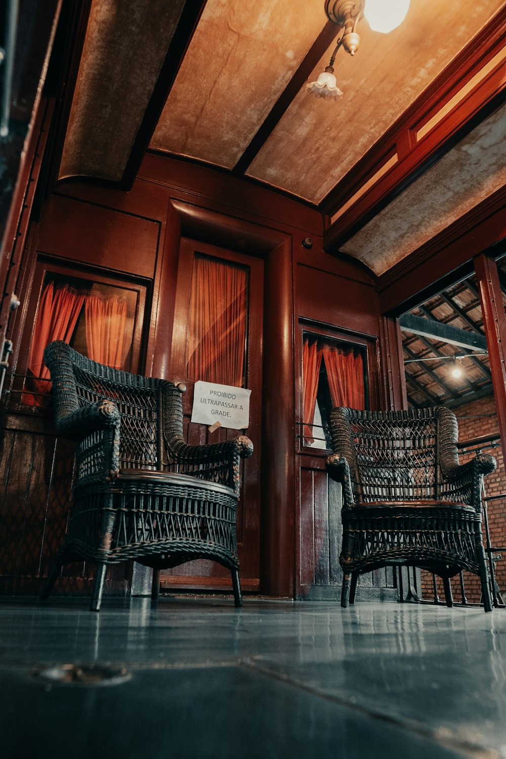 a couple of wicker chairs sitting in a room