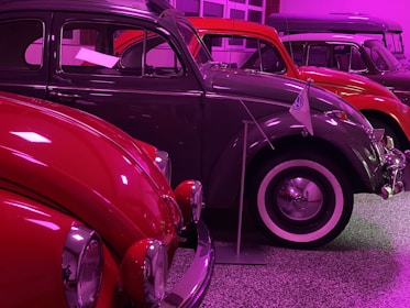 A vibrant retro car show featuring gleaming classic VAG models lined up with enthusiastic crowds.