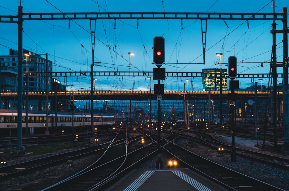 a train traveling down train tracks next to a train station