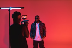 a man standing in front of a camera taking a picture