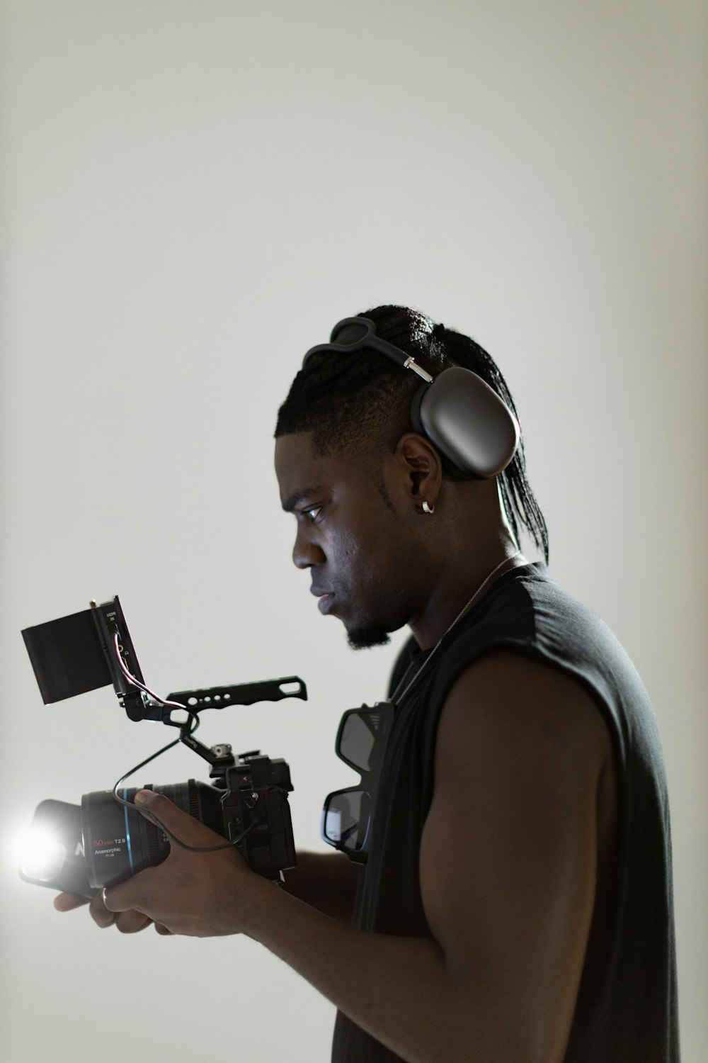 a man with headphones on holding a camera