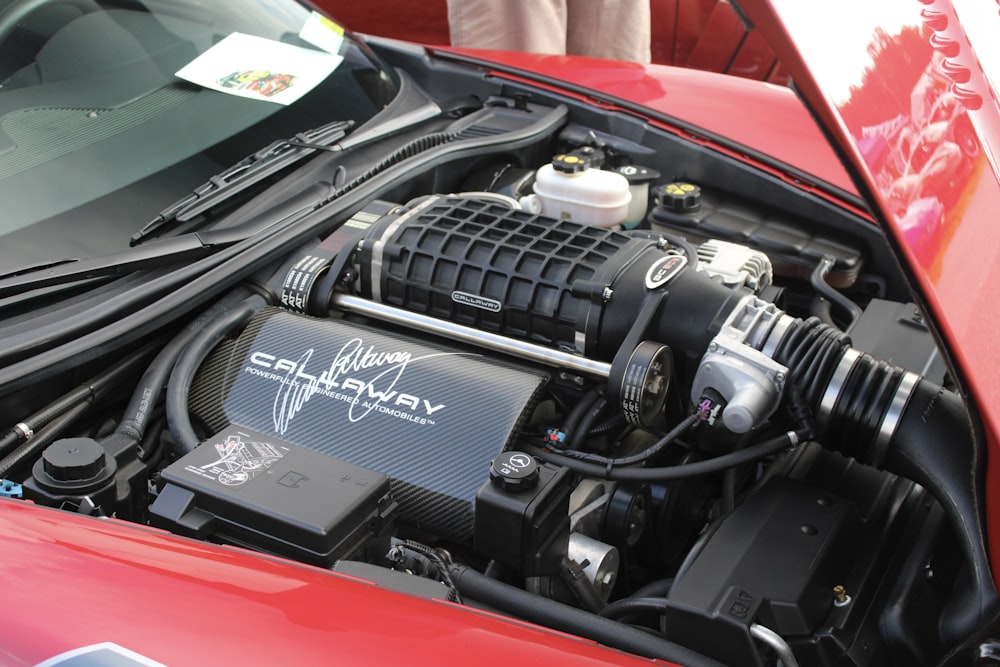 a close up of a car's engine and its hood