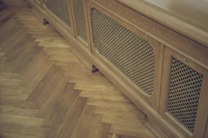 Warm glow from heating vents subtly integrated within elegant wooden flooring