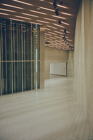 a large room with a white floor and a wall