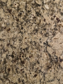 The surface displays a speckled pattern with various shades of brown, black, and cream, typical of a granite countertop.