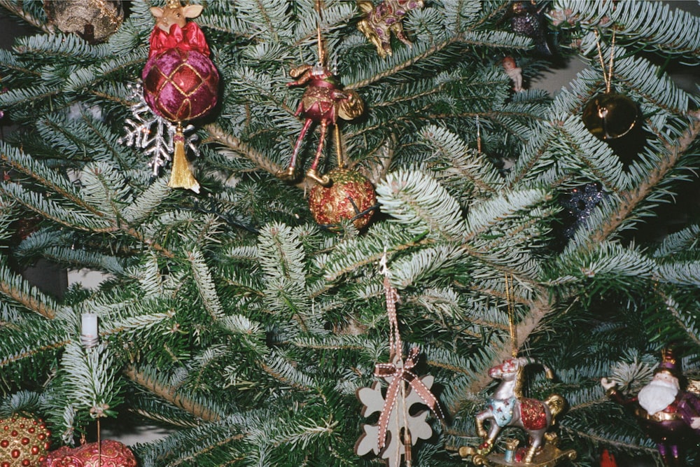 a close up of a christmas tree with ornaments on it