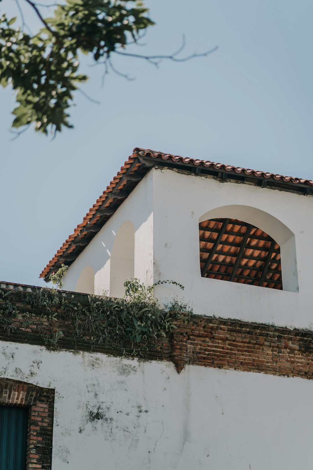 a white building with a red tiled roof