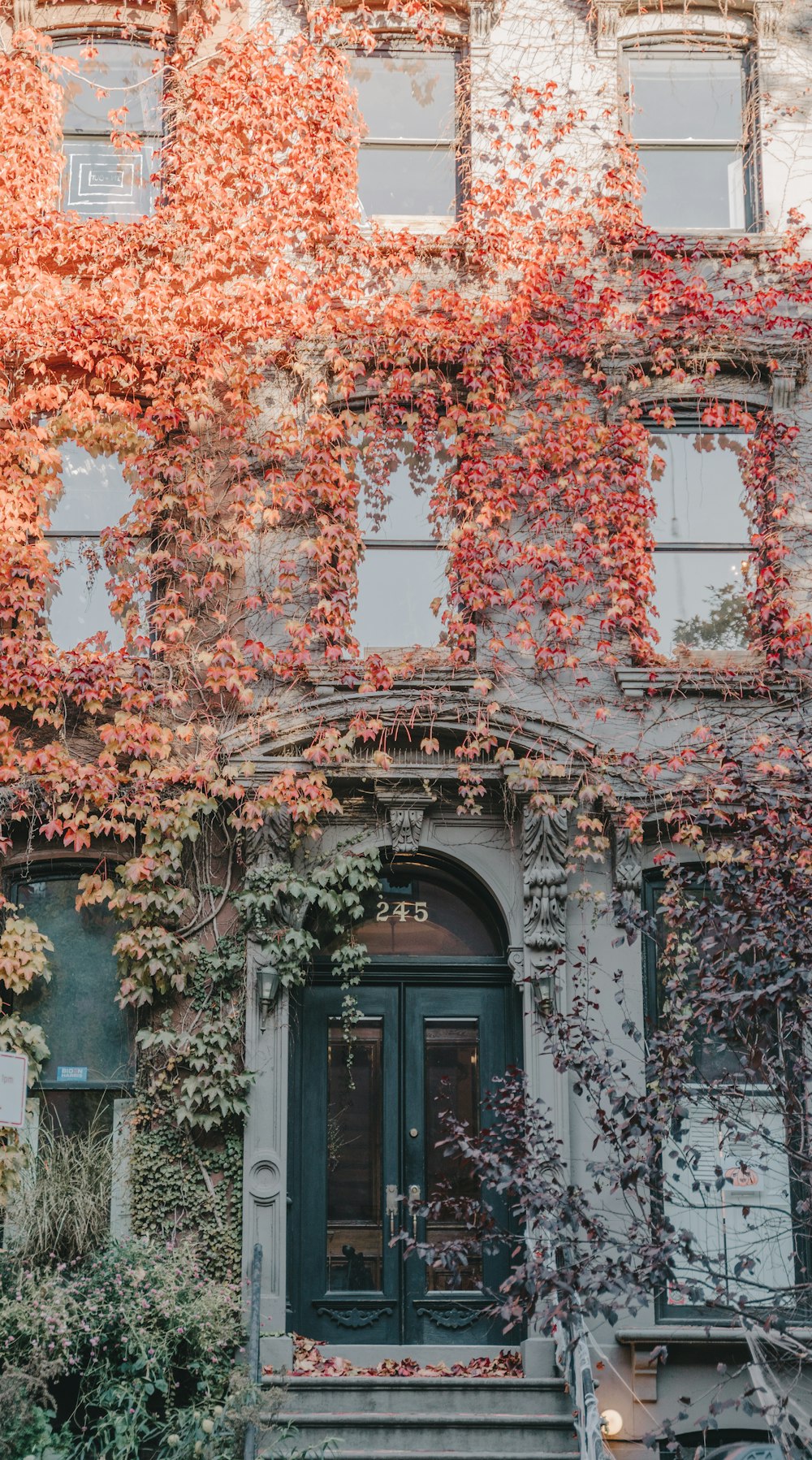 an old building with ivy growing on the side of it