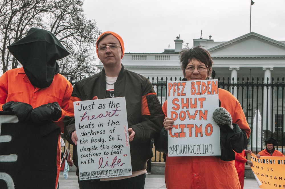 a group of people holding protest signs in front of a building