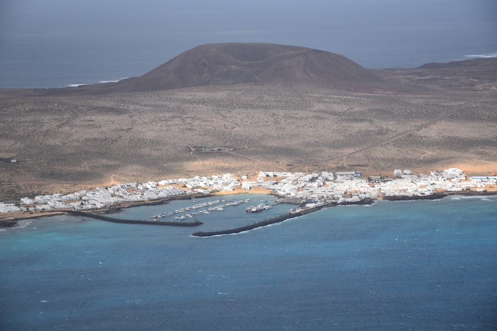 an aerial view of a small town and a body of water