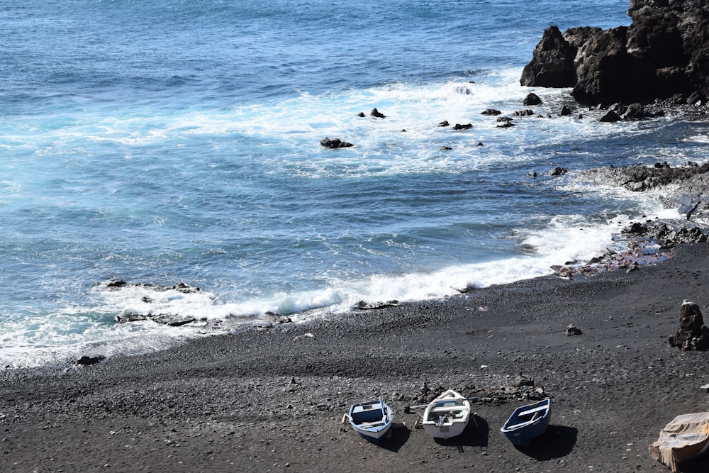 a couple of small boats sitting on top of a beach