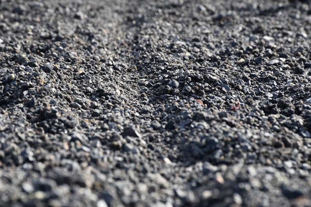 a close up of a road with rocks and gravel