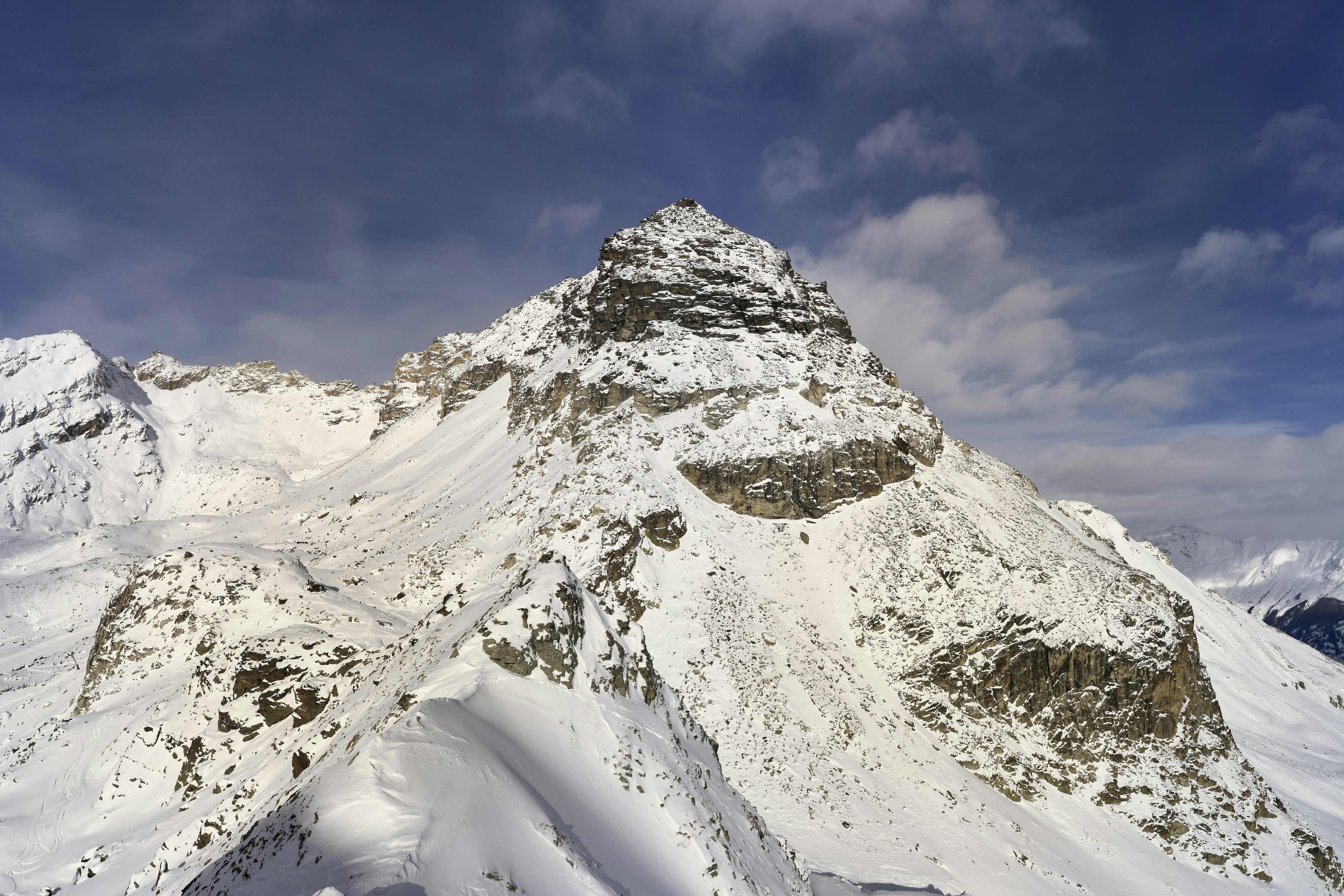 a snow covered mountain with a sky background