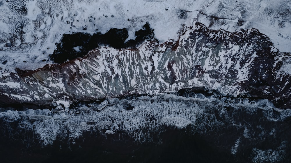 an aerial view of a snow covered mountain