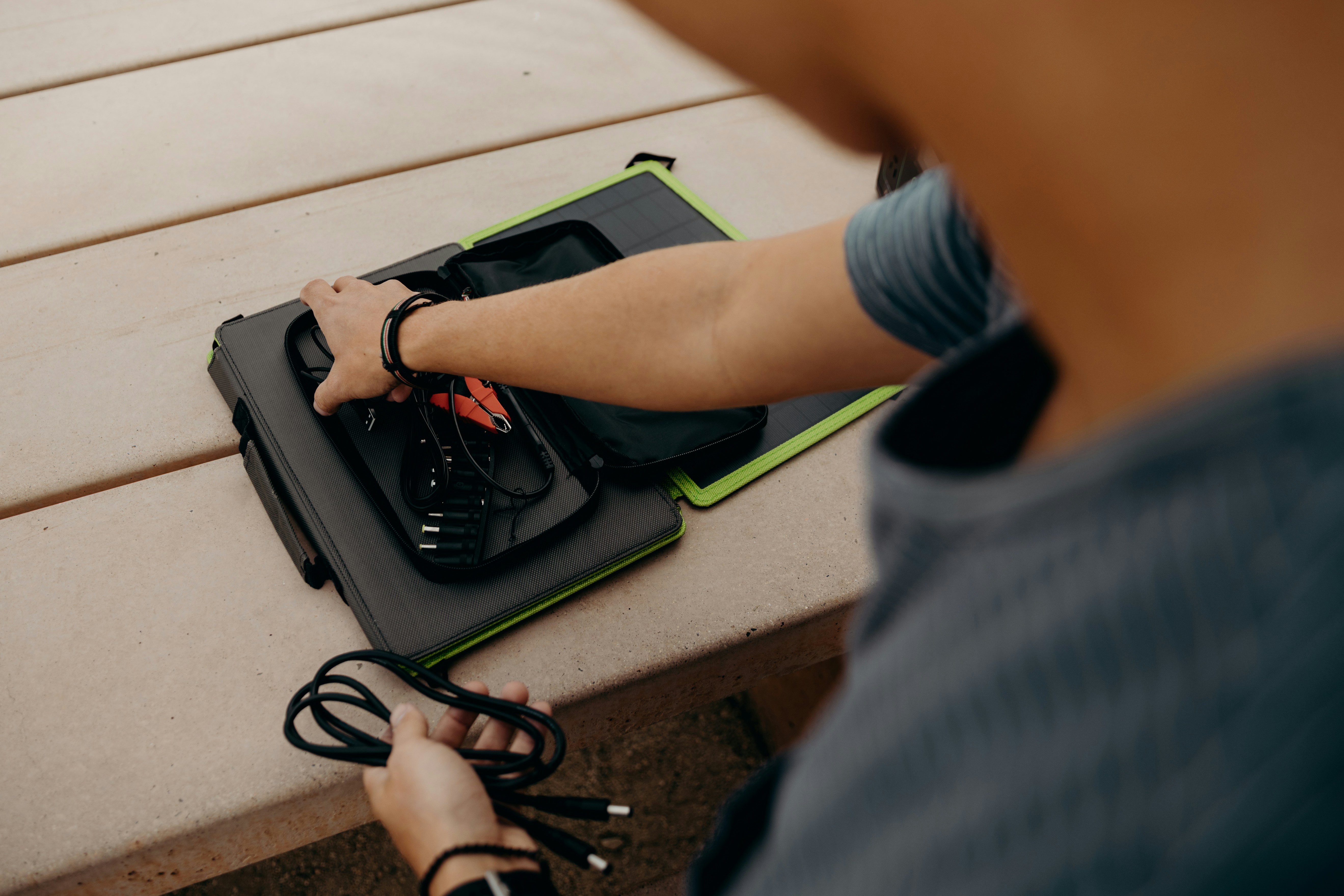 a person sitting at a table with a laptop on it