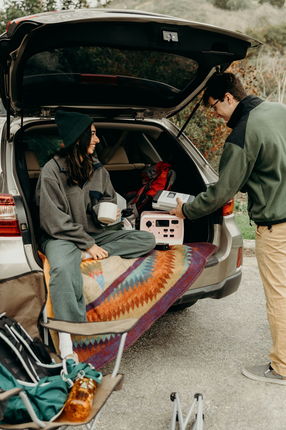 a couple of people sitting in the back of a car