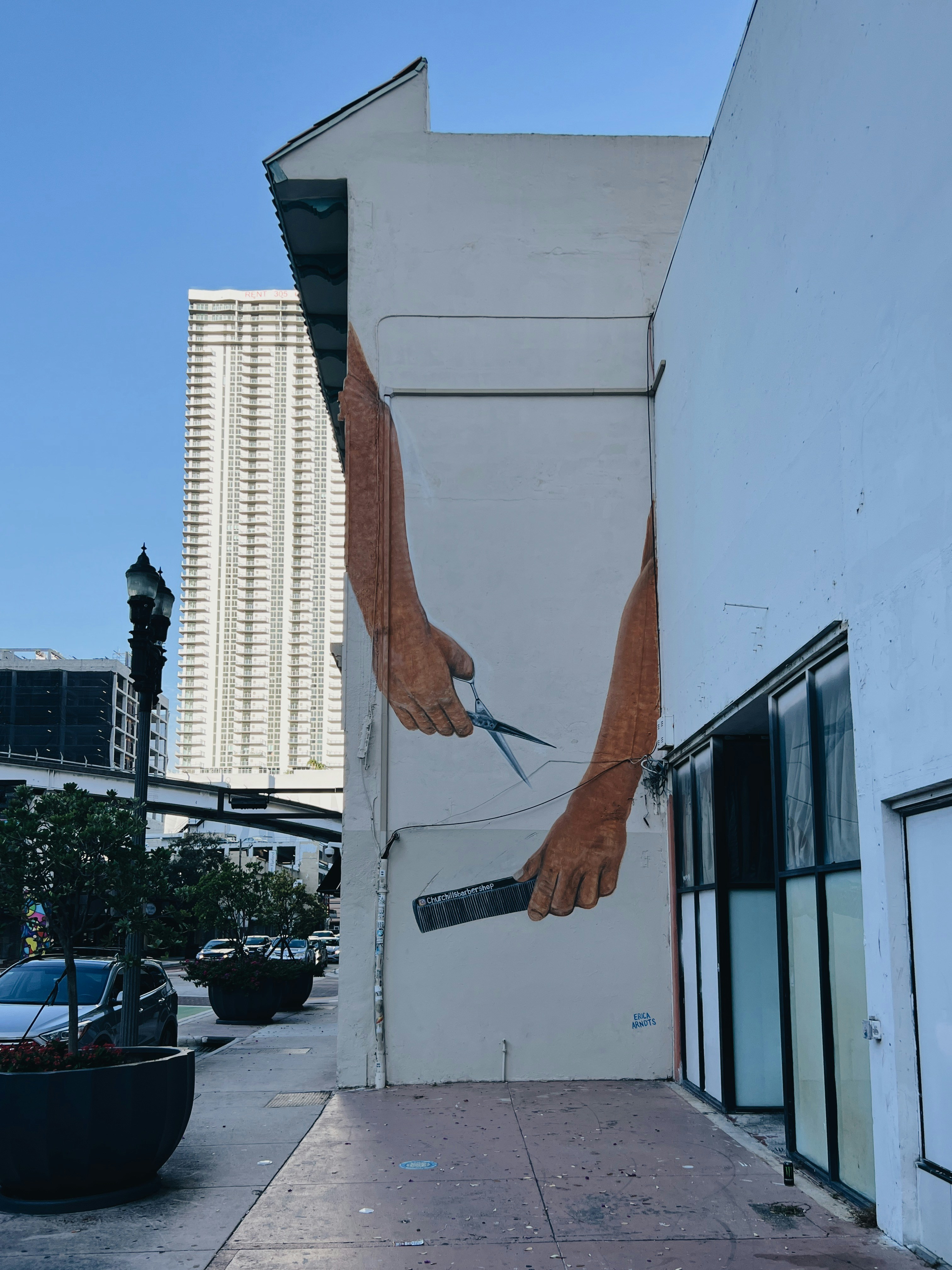 a mural on the side of a building of a hand holding a knife