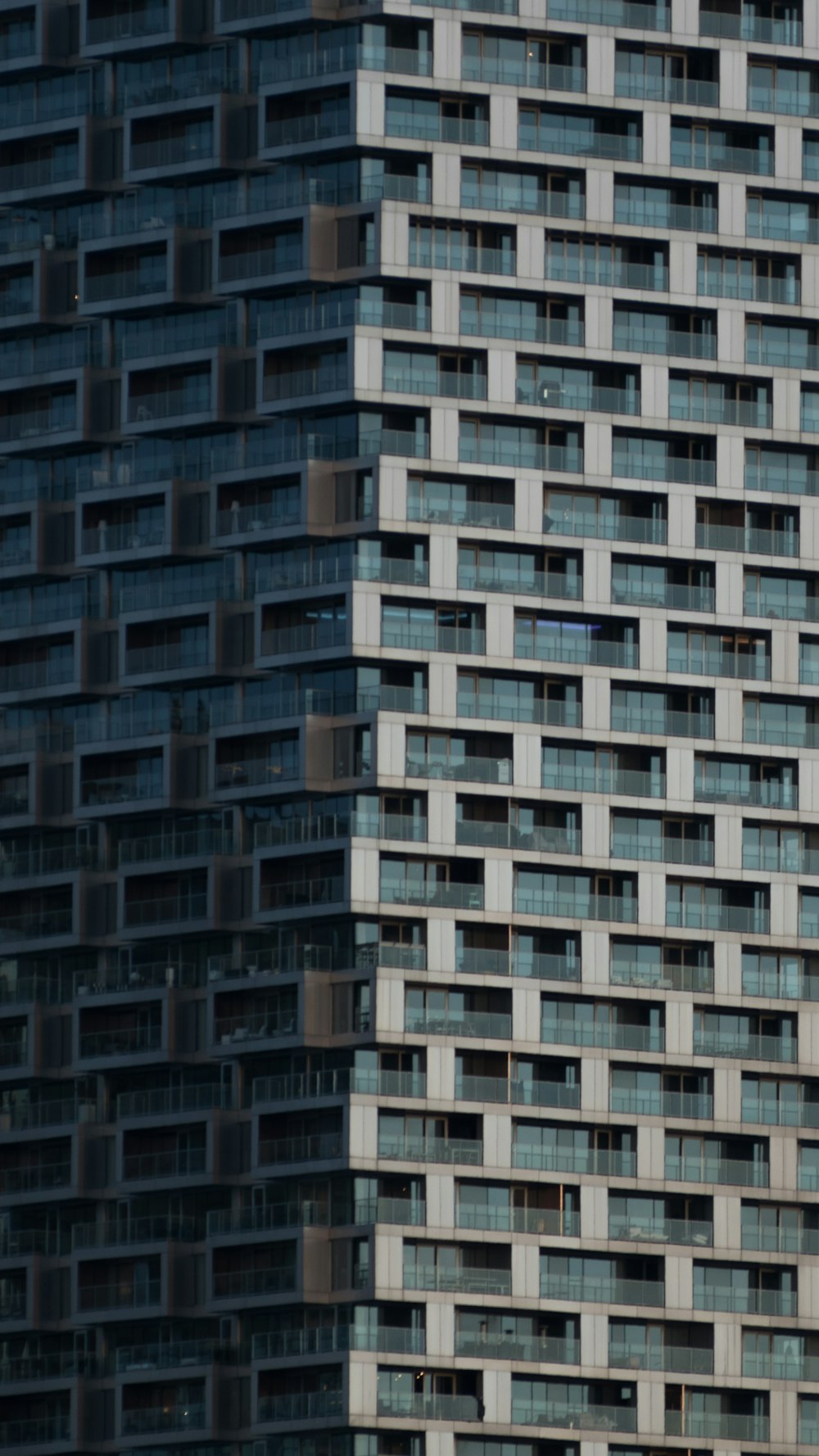 an airplane flying in front of a very tall building