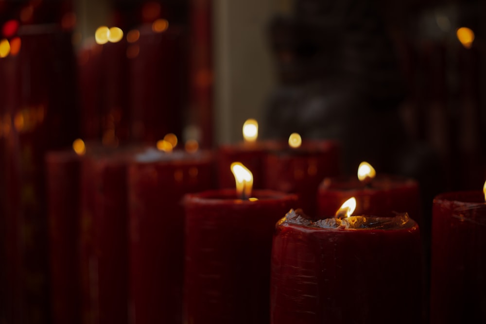 a group of red candles sitting next to each other