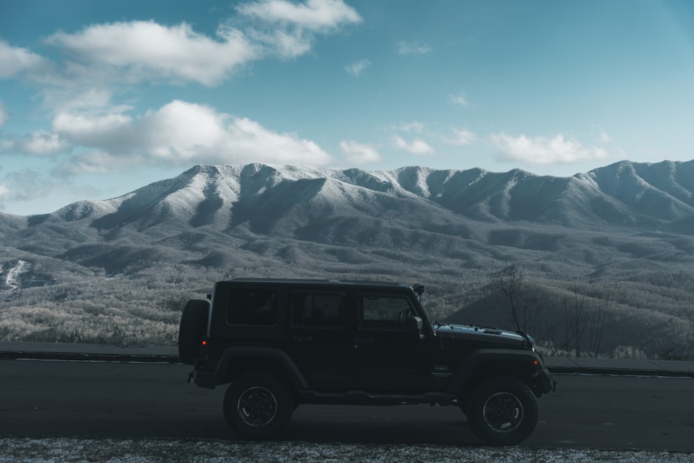 a black jeep parked on the side of a road