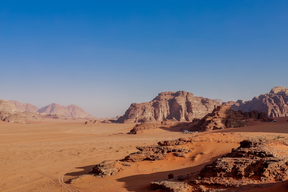 a desert landscape with mountains in the background