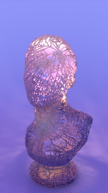 Close-up of a feminine handmade sculpture glowing softly under warm light