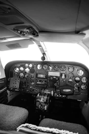 a black and white photo of the cockpit of a plane