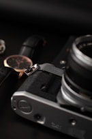 A close-up of a classic watch paired with leather accessories.