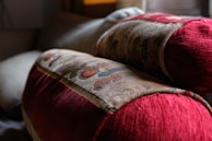 A pair of matching couple pillows with delicate embroidery on a cozy sofa.