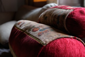 Close-up of a plush bed with Persian-style cushions and throws.