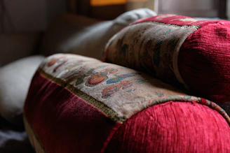 Close-up of luxury cushions and covers in rich textures and colors enhancing a stylish sofa.