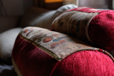 Close-up of decorative cushions and throws adding warmth to a sofa.