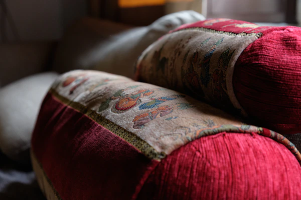 Close-up of luxury cushions and covers in rich textures and colors enhancing a stylish sofa.