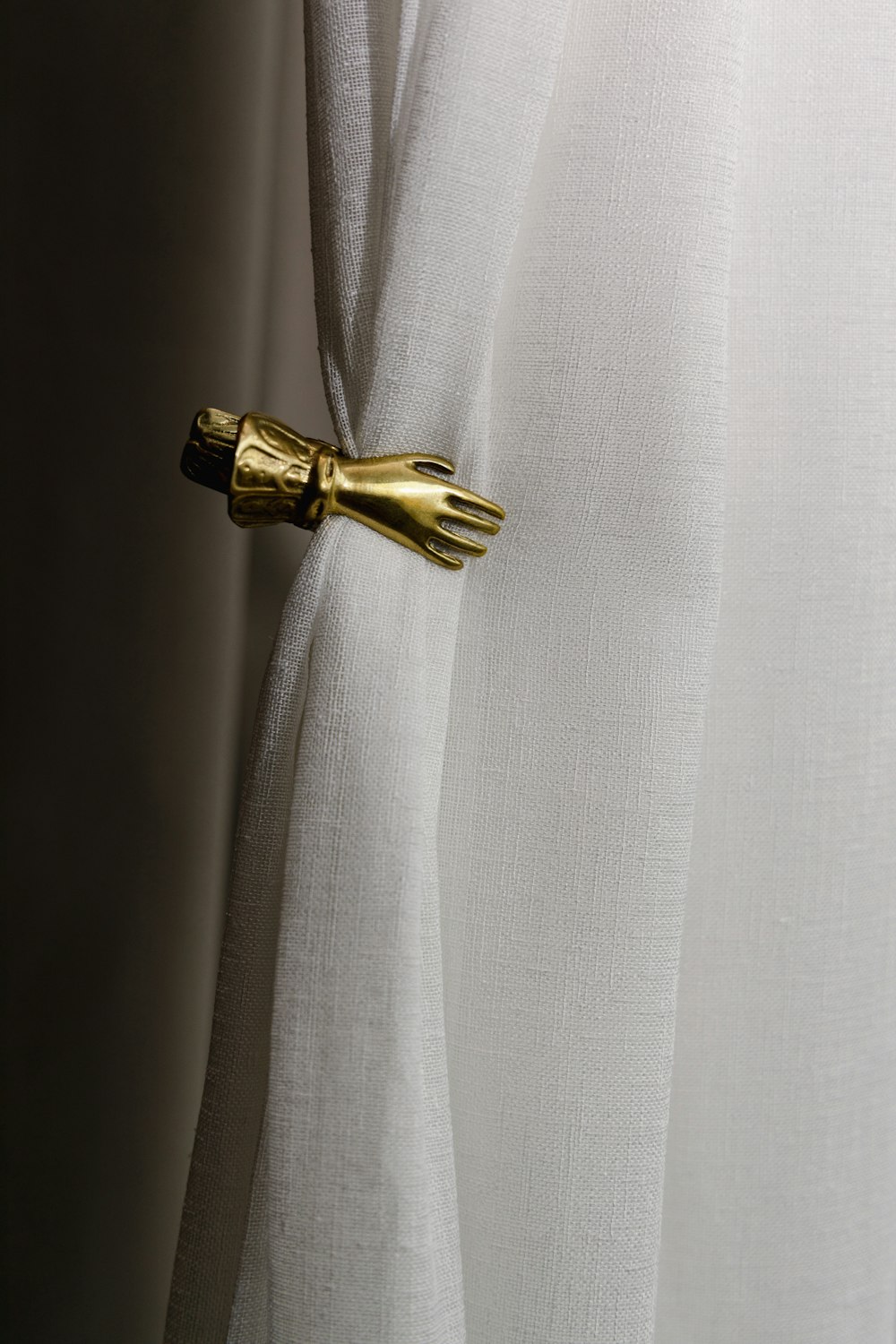 a close up of a curtain with a gold handle on it