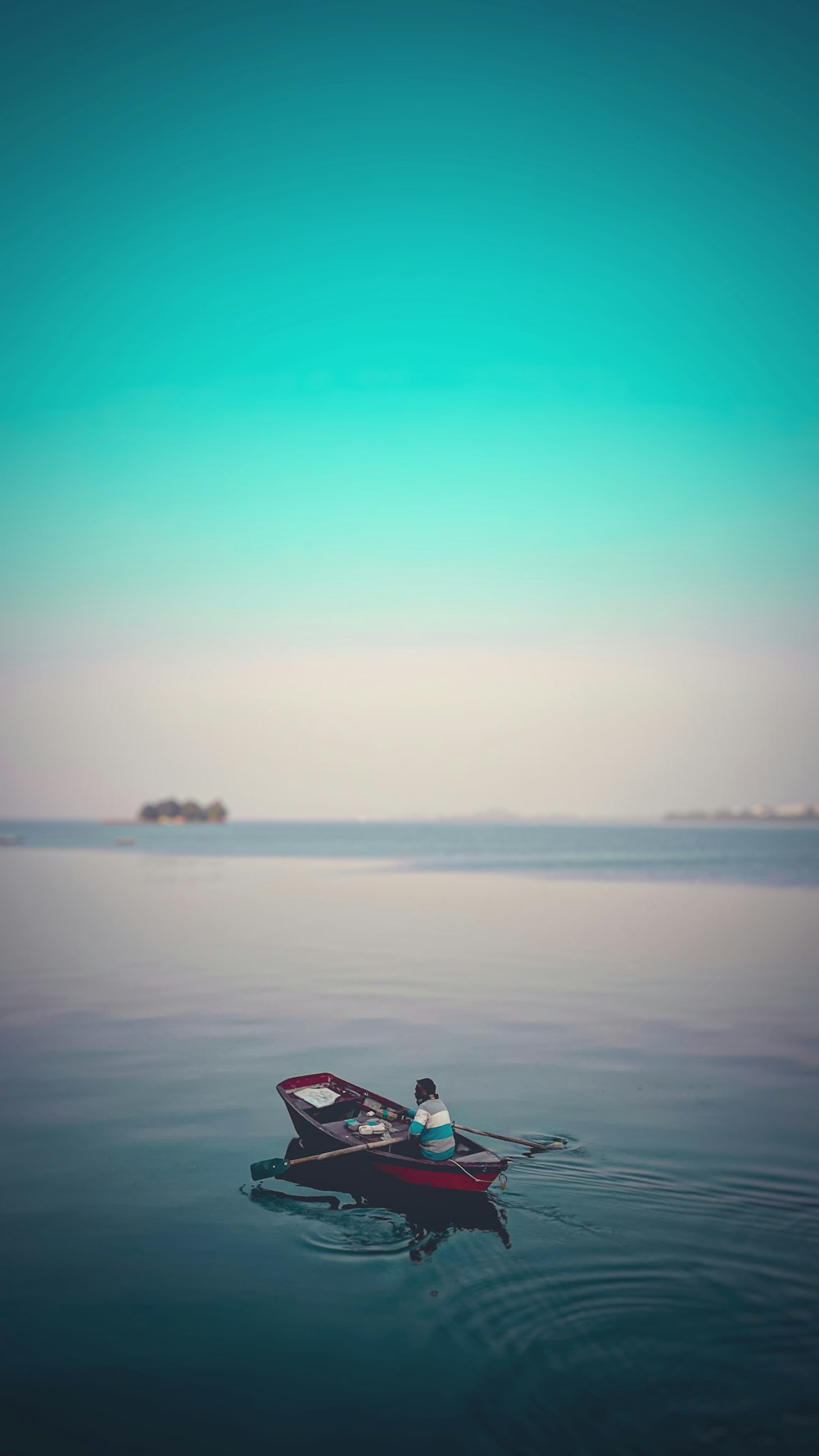 a person in a small boat on a body of water