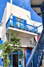 A bright, modern veranda with blue accents and integrated custom shutters.