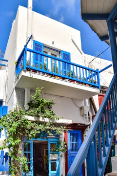 Before and after photo of a freshly painted Laval home exterior with crisp blue and white tones.