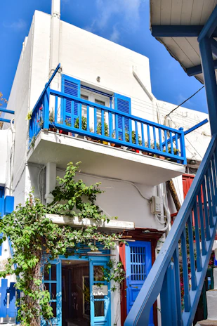 A bright, modern veranda with blue accents and integrated custom shutters.