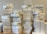 A large number of stacked white boxes, each labeled with the Apple logo and the word 'iPad'. The boxes are neatly arranged in several tall piles on a surface, suggesting a substantial inventory of Apple products.