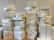 A large number of stacked white boxes, each labeled with the Apple logo and the word 'iPad'. The boxes are neatly arranged in several tall piles on a surface, suggesting a substantial inventory of Apple products.