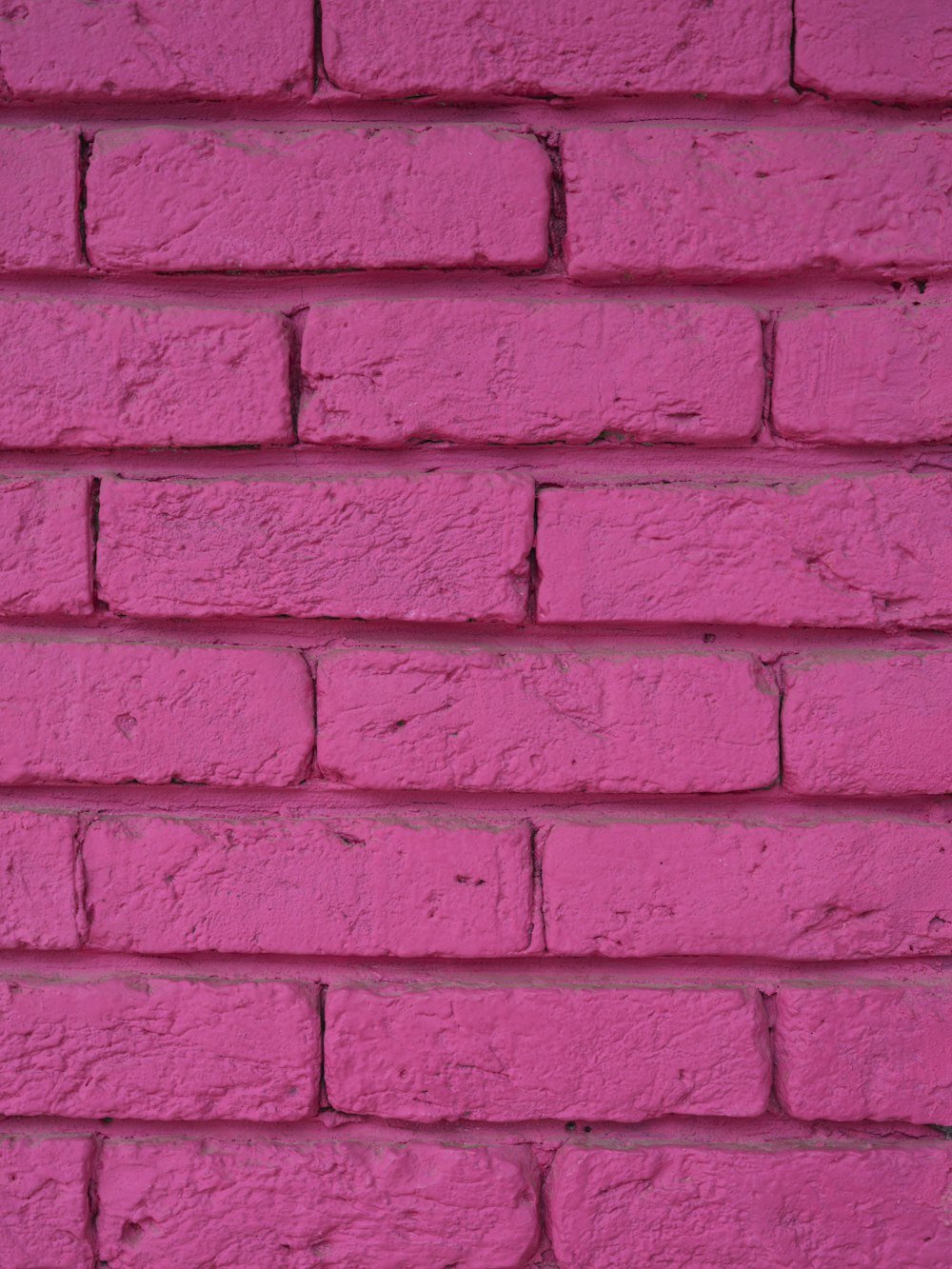 a close up of a pink brick wall