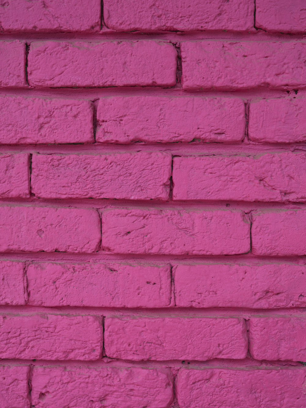 Un primer plano de una pared de ladrillo rosa