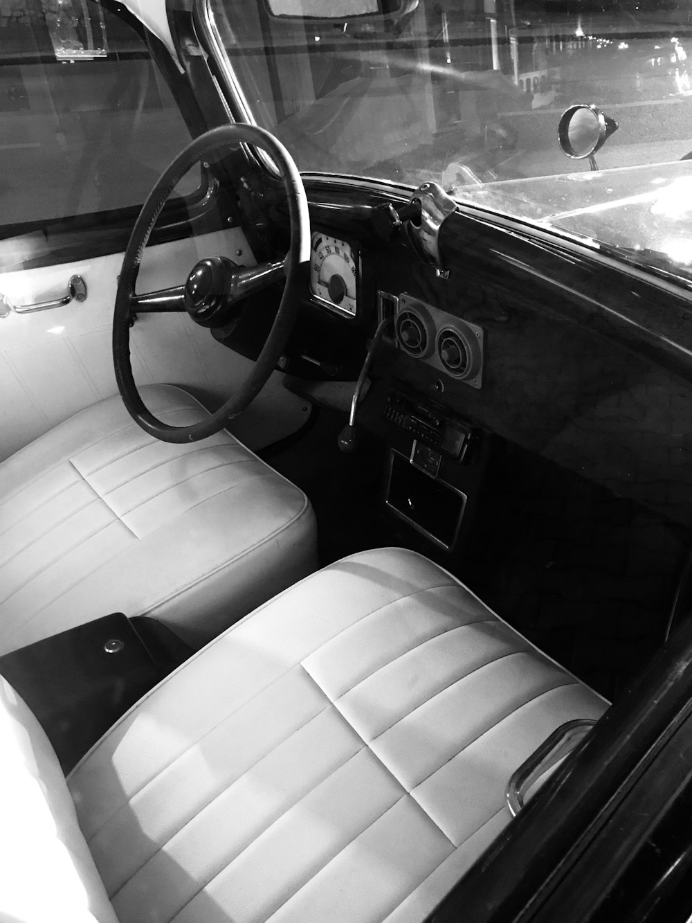 a black and white photo of the interior of a car